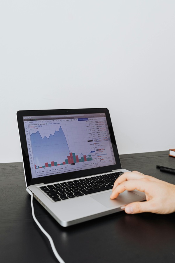 Stack of stablecoin tokens beside a trading dashboard